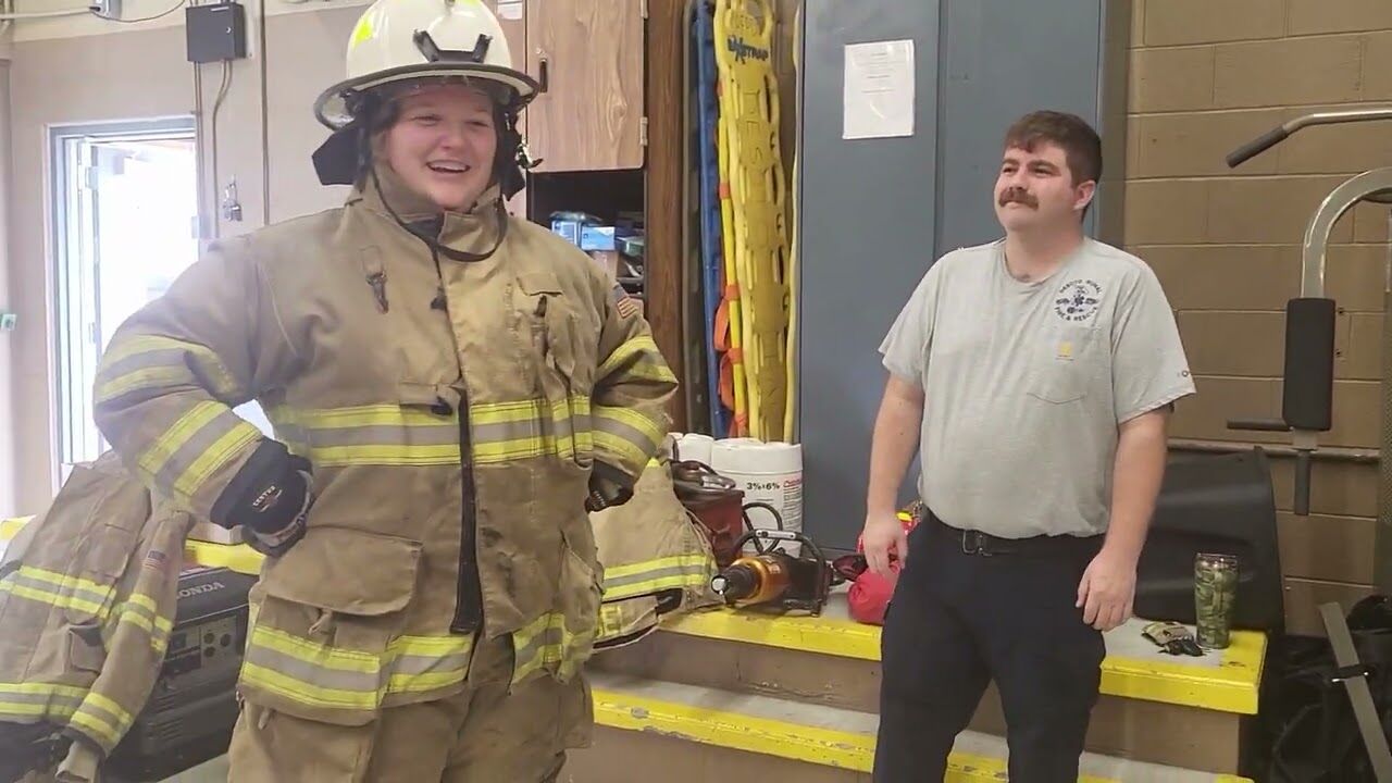 Local firefighters guide reporters through a training session